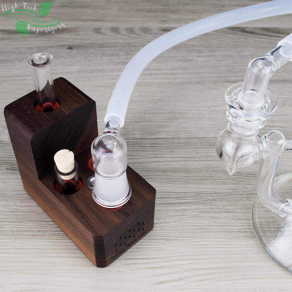 Walnut hydrobrick maxx vaporizer connected to glass rig with whip adapter